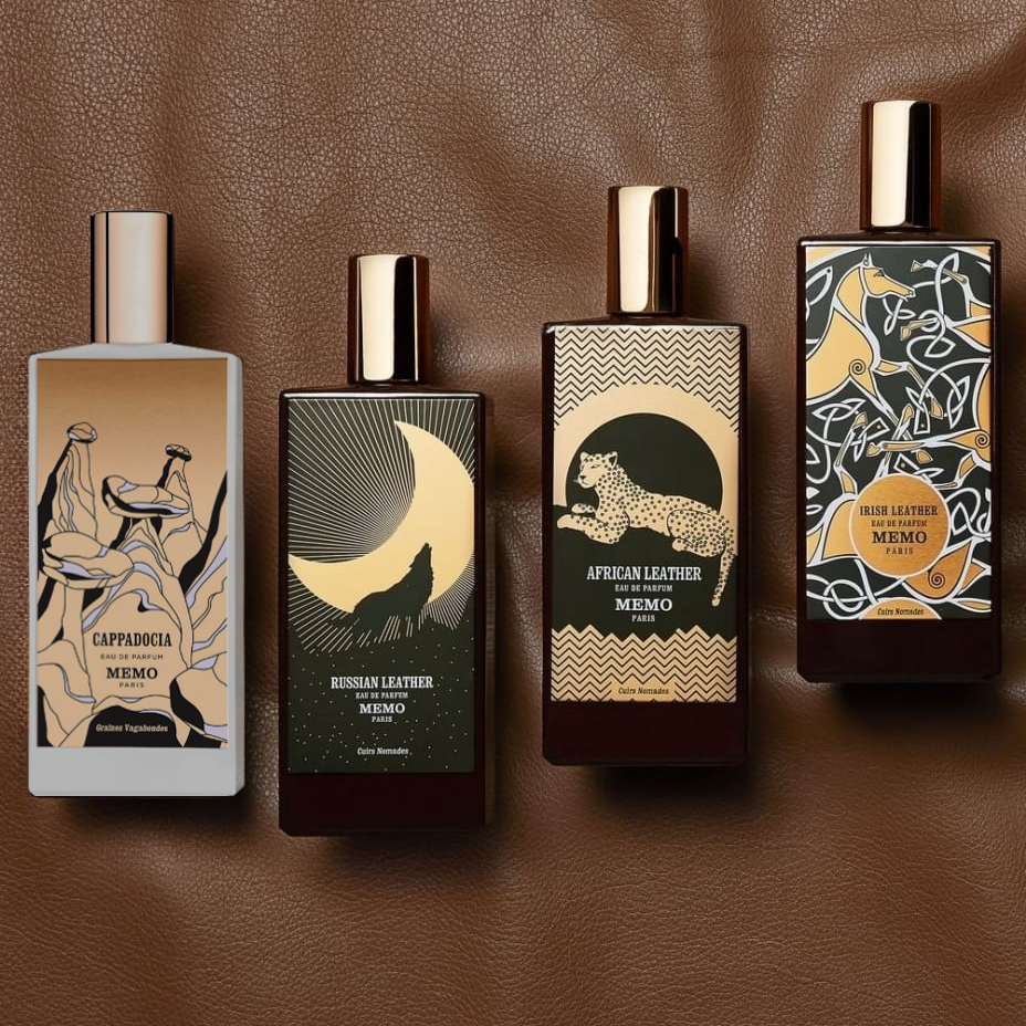 Memo Paris fragrance bottles Cappadocia, Russian Leather, African Leather, and Irish Leather displayed on a rich brown leather backdrop.