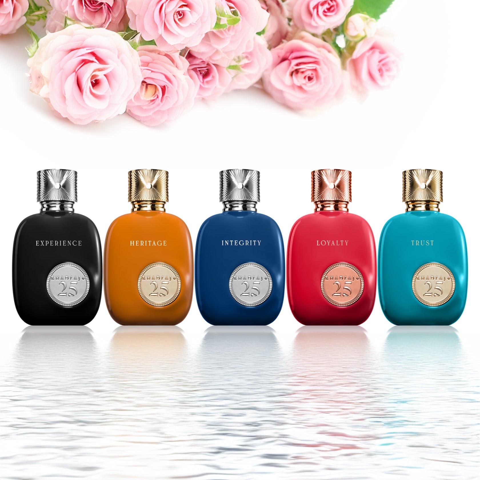 Five colorful Khadlaj 25th Anniversary perfume bottles—black, amber, blue, red, and turquoise—stand in a row with roses above and a reflective water surface below, symbolizing elegance and celebration.
