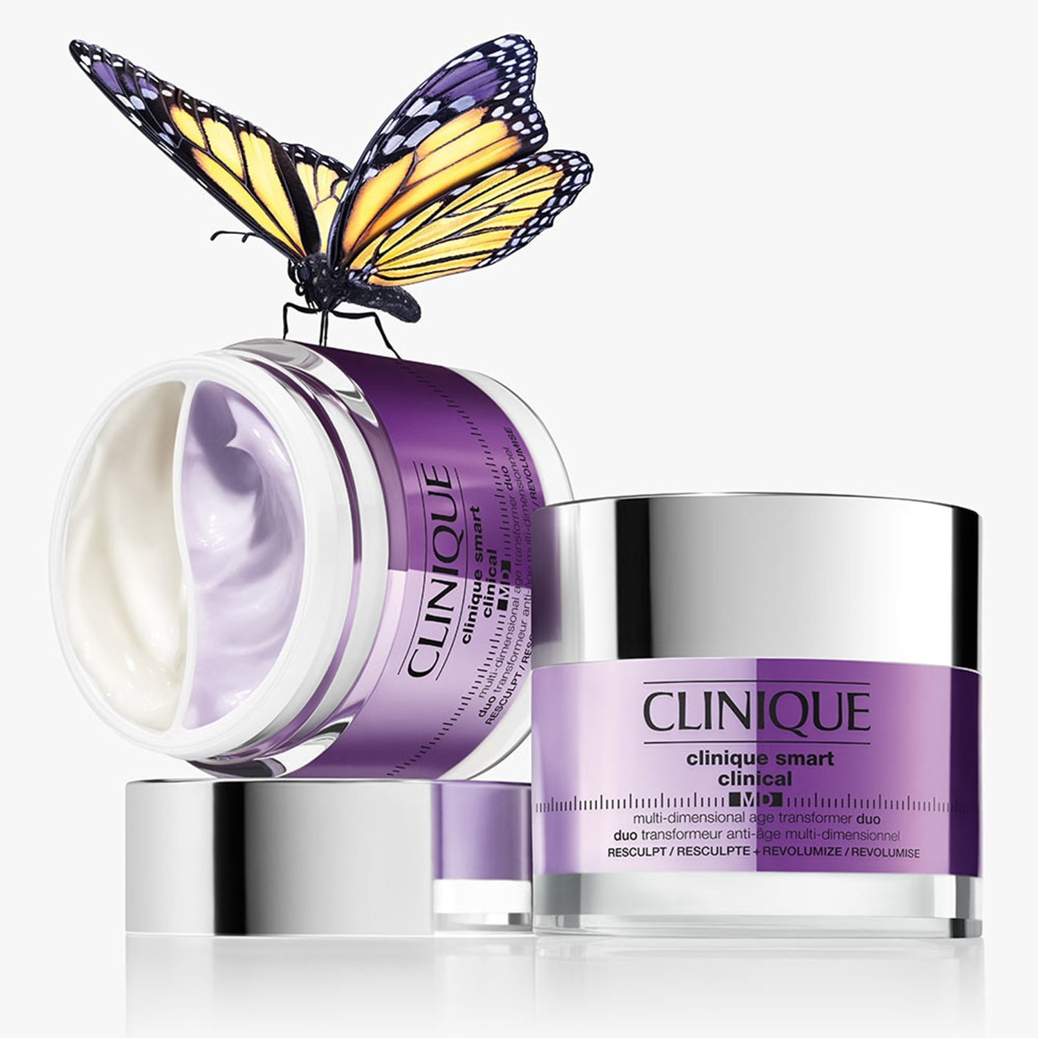 Clinique Smart Clinical MD multi-dimensional age transformer duo in purple jars with chrome lids, one open showing cream textures, decorated with a butterfly.