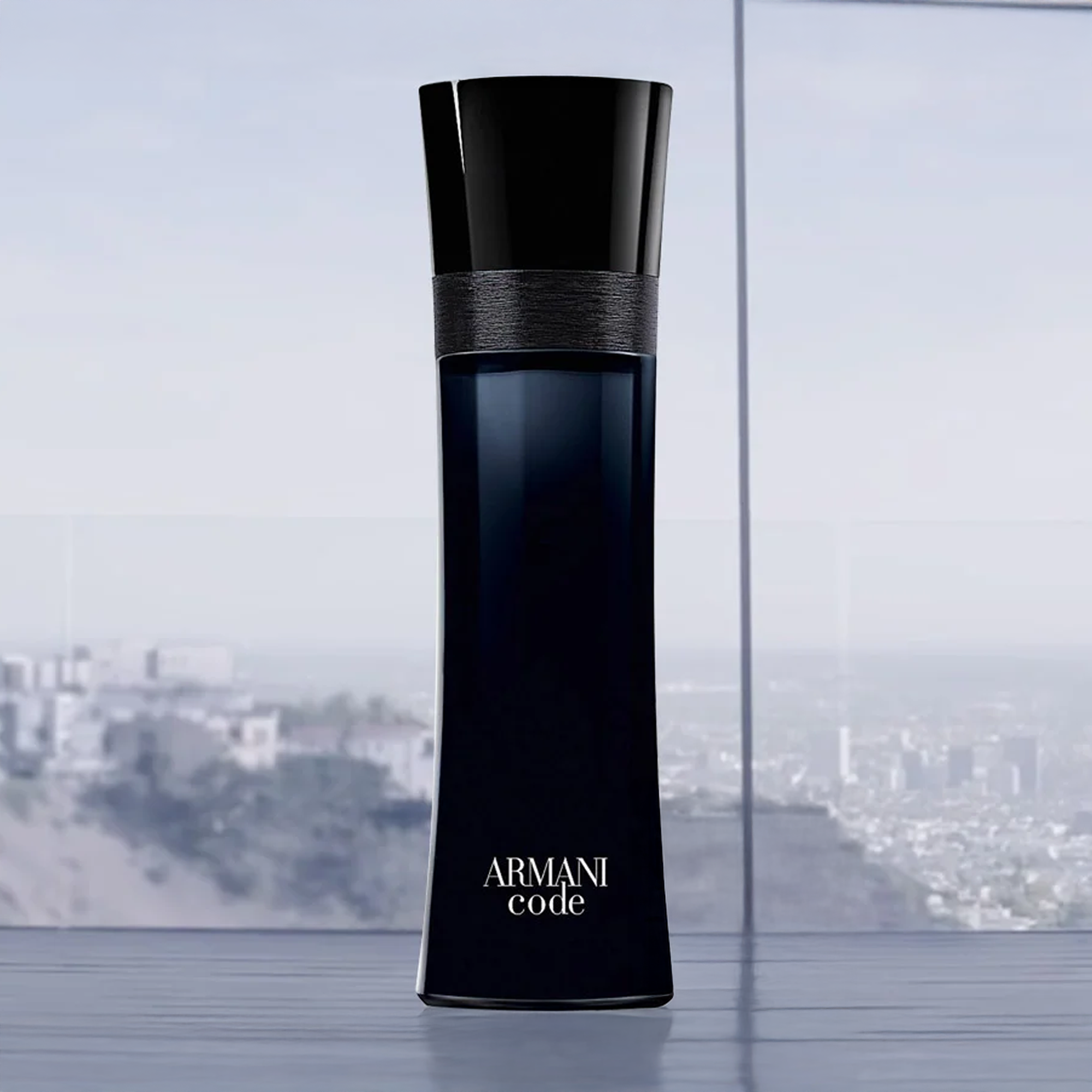 ChatGPT said:

A sleek black Armani Code perfume bottle stands tall against a cityscape backdrop, reflecting sophistication and modern masculinity.
